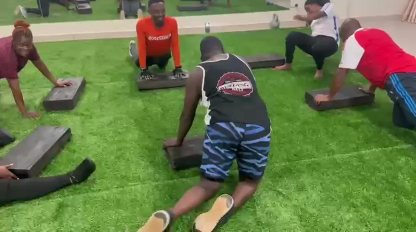 Members doing step-ups on low platforms across the turf studio
